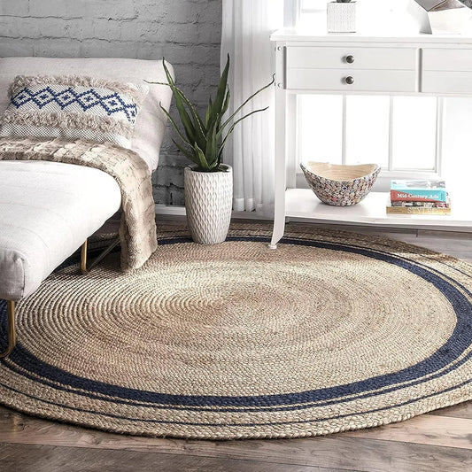 Natural beige round jute rug with black concentric braided border on white background