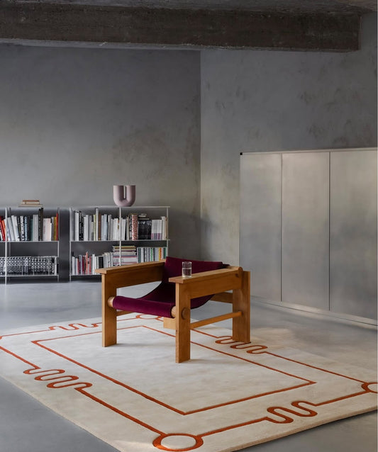 Cream and terracotta geometric hand tufted rug with modern linear abstract design in contemporary interior