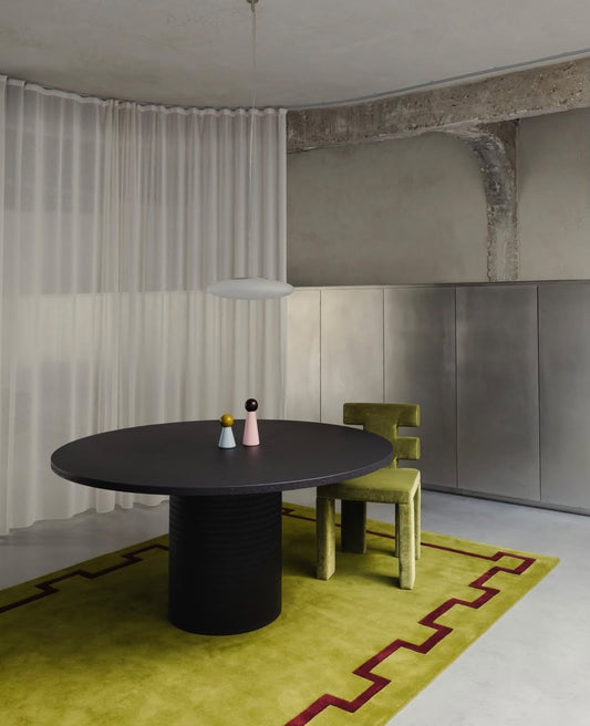 Lime green and burgundy Greek key geometric hand tufted rug styled in a modern contemporary interior